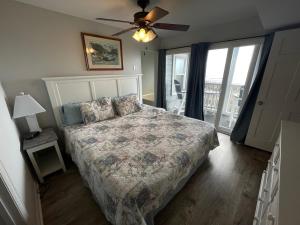a bedroom with a bed and a ceiling fan at Cape Coddages I 103 Condo in Myrtle Beach