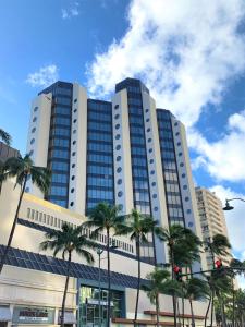 a large building with many windows in a city at Hyatt Centric Waikiki Beach in Honolulu
