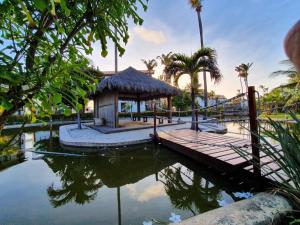 ein Dock mit einem Pavillon neben einem Wasserkörper in der Unterkunft Taiba Beach Resort 01 Apto 2 quartos in São Gonçalo do Amarante
