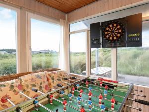 a living room with a table and a dart board at 10 person holiday home in Harbo re in Harboør