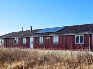a red building with solar panels on it at 10 person holiday home in Harbo re in Harboør