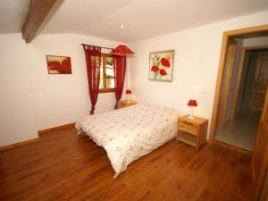 a bedroom with a bed and a wooden floor at Authentic chalet with terrace in Harreberg in Hommert