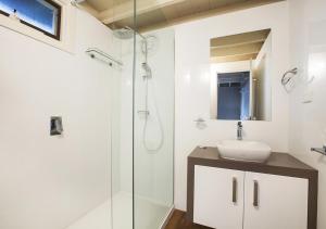 a bathroom with a sink and a glass shower at Diamantina in Dinner Plain +4 photos