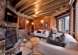 a living room with a couch and a fireplace at Montane in Dinner Plain