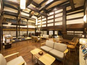 a living room with a couch and chairs and tables at Ryokan Asunaro in Takayama