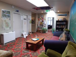 a living room with a couch and a coffee table at Ariki Backpackers in New Plymouth
