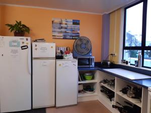 a kitchen with two refrigerators and a counter top at Ariki Backpackers in New Plymouth