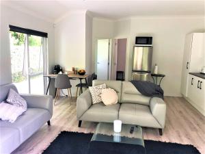 a living room with a couch and a table at Robyn's Retreat in Hamilton