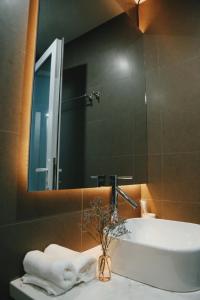 a bathroom with a sink and a mirror at Moonlight House & Apartment Nha Trang in Nha Trang