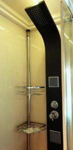 a shower in a bathroom with a glass shower backdoor at Casa Ovi in Saturn