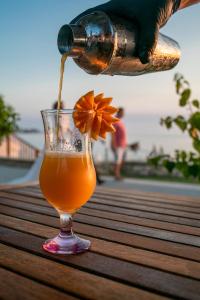 a drink being poured into a glass on a table at Side Beach Hotel in Side
