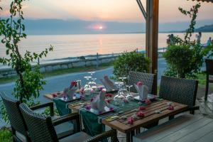 a table with chairs and a table with a view of the ocean at Side Beach Hotel in Side