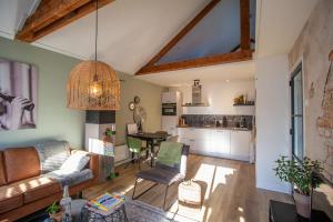 a living room with a couch and a table at Stads-Loft Goes in Goes