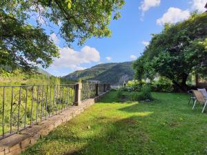 a fence in a yard with a view of mountains at Posada Magoria in Ansó