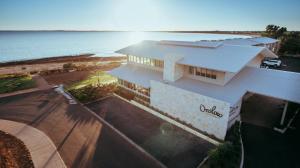 an aerial view of a building next to the ocean at Onslow Beach Resort in Onslow