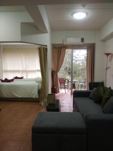 a living room with a couch and a bed at Avatara condo A63 by malai in Ban Tha Fat