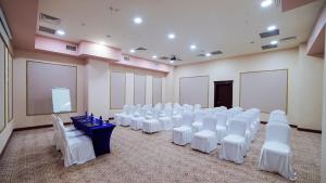 a room with rows of white chairs and a screen at Wyndham Batumi in Batumi +74 photos