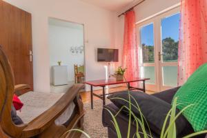 a living room with a couch and a table at Apartments Marija Bibić in Hvar