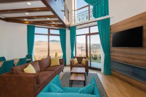 a living room with a couch and a tv at Vila S6 in Zlatibor