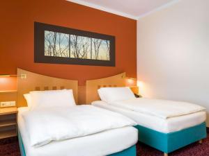Postel nebo postele na pokoji v ubytování Mercure Hotel Ingolstadt
