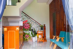 a hallway with a staircase with flowers and a table at SUNRISE HOTEL in Con Dao