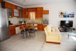 a kitchen and living room with a couch and a table at Mary's dreams Villa in Symi