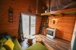 a living room of a log cabin with a sliding glass door at Sagando - Floating house on Sava river in Belgrade
