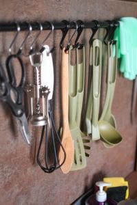 a bunch of kitchen utensils hanging on a wall at Sagando - Floating house on Sava river in Belgrade