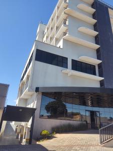 a large white building with a lot of windows at Hotel Quartzo in Cristalina