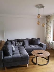 a living room with a blue couch and a table at Hotel Hegenbarths in Cochem