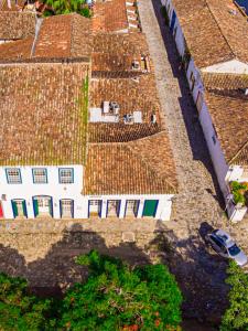 an overhead view of roofs of buildings with a car at Pousada Porto Imperial in Paraty