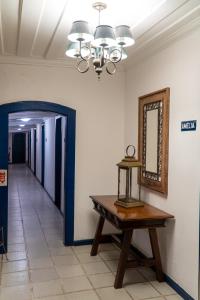 
a room with a table and a mirror in it at Pousada Porto Imperial in Paraty
