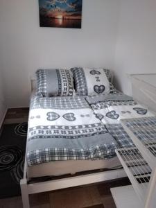 ein Bett mit einer Bettdecke und Kissen darauf in der Unterkunft Am Schwielochsee 2 in Speichrow