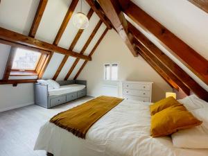 a bedroom with a large bed in a attic at Le Cocon - Classé 3 étoiles - Avec garage, à 5mn du centre in Strasbourg