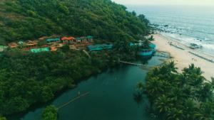 an aerial view of a resort and a beach at Sweet Valley Cottages in Arambol