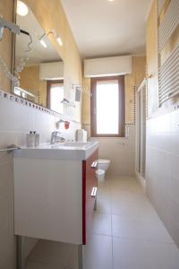 a bathroom with a sink and a toilet at Hotel Deborah in Milano Marittima