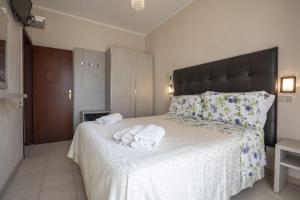 a bedroom with a large bed with towels on it at Hotel Deborah in Milano Marittima