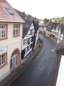 an empty street in a town with buildings at Ferienwohnungen - An der Kunstakademie in Heimbach +5 photos