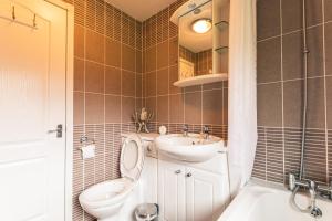 a bathroom with a toilet and a sink at Hunters Lodge With Hot Tub in Malton +16 photos