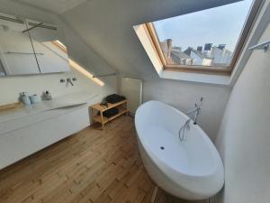 a bathroom with a white toilet and a window at Spacious Loft in the Historical Centre in Ghent