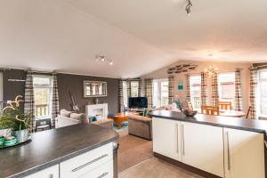 a kitchen and living room with a living room at Kingfisher Lodge with Hot Tub in Malton