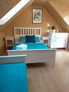 a bedroom with a large bed in a attic at Szafir in Kuźnica