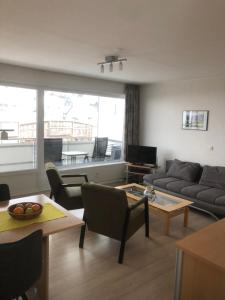 a living room with a couch and a table at Appartement Bouwens in Winterberg +6 photos