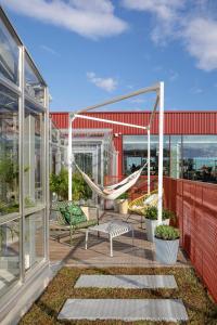 a patio with a hammock and swings on a building at Zoku Copenhagen in Copenhagen