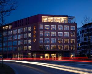 a large building with a clock on the side of it at Zoku Copenhagen in Copenhagen