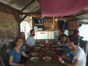 a group of people sitting around a table at Asari Timo Cottage in Karimunjawa