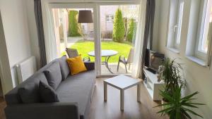 a living room with a couch and a tv and a table at 4* Ferienwohnung Neukirchen im Erzgebirge in Adorf