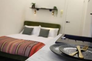 a table with a plate and a bed in a room at Boutique Stylish Self Contained Studio Shropshire in Pattingham