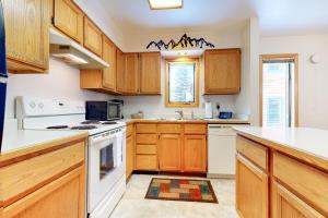 a kitchen with wooden cabinets and white appliances at 515 Cache in Jackson