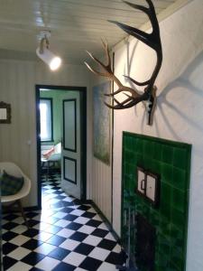 a room with a checkered floor and a door with a deer head on at Alpchalet Oberstdorf in Oberstdorf +72 photos